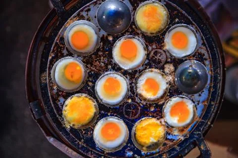 Selective Focused Cooked Quail Eggs in heating mantle (indented frying pan). Stock Photos