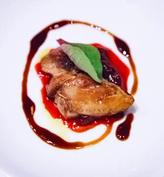 Selective Focused pan seared Foie Gras with berry sauce decoration served on Stock Photos