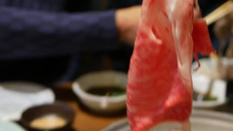 Selective focusing pov to raw meat wagyu japanese A5 using chopstick pick u.. 스톡 동영상 329671543
