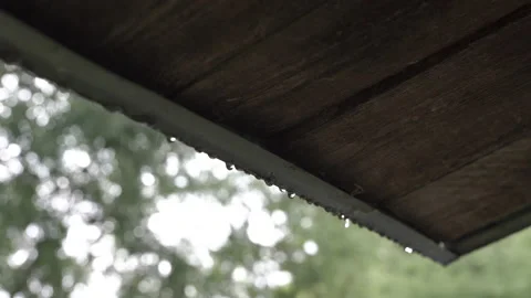 Selective footage of rain drops falling down from a gutter guard Stock Footage 227572875