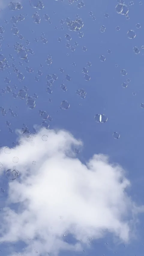 A selective footage of soap bubbles floating against a blue sky Stock Footage 278310843