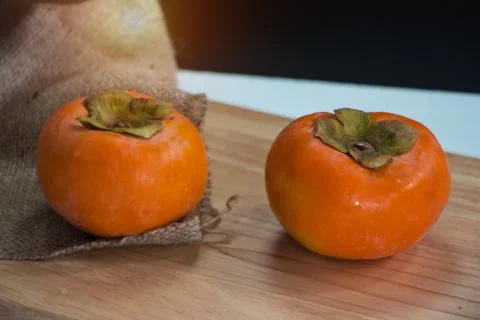 In selective of the persimmon at the right side of background,beside blurred  Stock Photos
