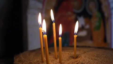 Selective tracking focus. Burning church wax candles in a sand candlestick Video stock 195851437