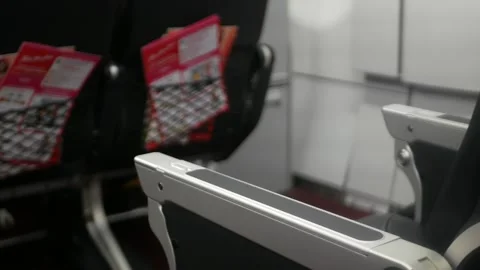 Selective view to arm rest of passenger airplane empty seat while operating.. Stock Footage 316392186