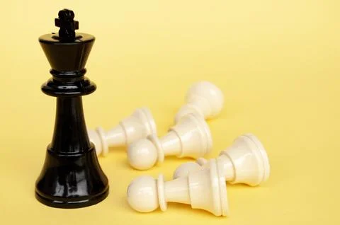 Selective view of chess king defeated white pawn with yellow cover backgrou.. Stock Photos