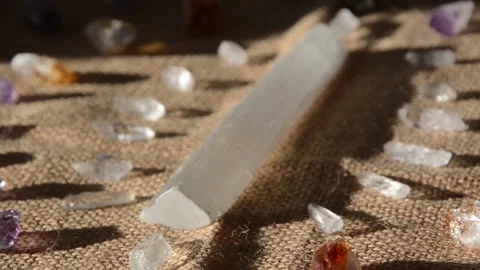 Selenite quartz on table sunbathing 스톡 동영상 130598814