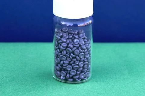 Selenium in a test tube in form of hemispheres. Stock Photos