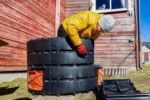 Self assembly of round modular compost bin from plastic panels woman homeow.. Stock Photos