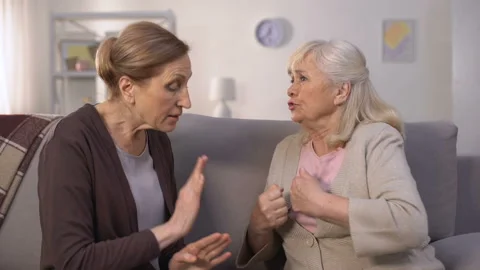 Self-assertive old women arguing and offending each other sitting in living room Stock Footage 110297136