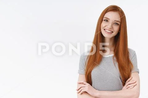 Self-assured charismatic ginger girl straight long red hair cross hands chest Stock Photos