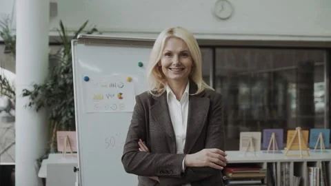 Self-assured friendly attractive middle-aged businesswoman in a stylish jacket Stock Footage 147741690