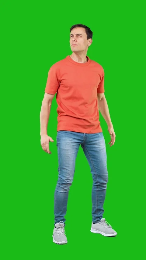 Self assured man looking at camera. Green background Stock Footage 245071944