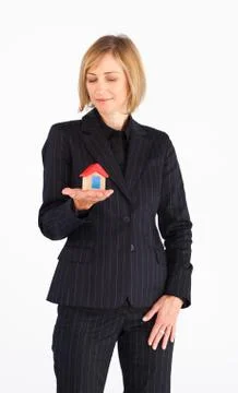 Self-assured mature businesswoman holding a house Stock Photos