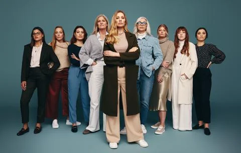 Self-assured woman standing with a group of empowered women Stock Photos
