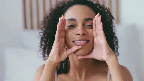 Self beauty routine concept. Young woman doing self facial massage. Relief of Stock Footage 168678072