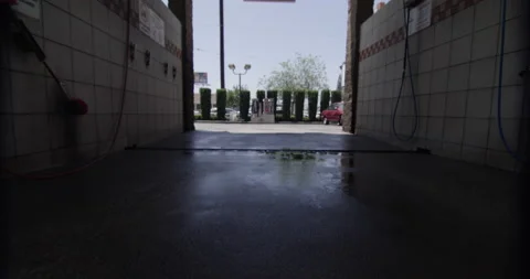 Self car wash camera dollys through wet recently used stall Stock Footage 138873023