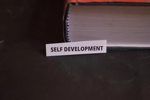 Self Development Paper Tab Inserted in Book Pages Symbolizing Life Improvemen Fotos Stock