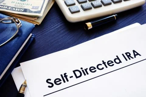 Self-Directed IRA SDIRA documents on a desk. Stock Photos