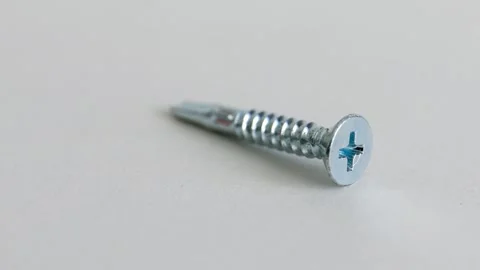 Self Drilling Phillips Countersunk Screws on White Background Close Up Stock Footage 333773744