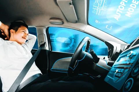 Self-drive autonomous car with man at driver seat. uds Stock Photos