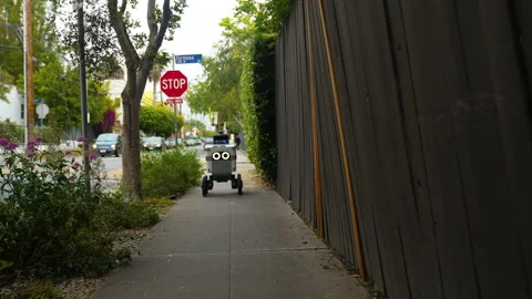 Self-driving delivery robot driving in the neighborhood of American city Stock Footage 242752789