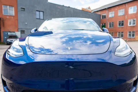 Self driving Tesla Model Y Exterior. Blue metallic, black titanium rims Stock Photos