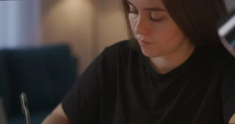 Self-education by online video tutorials and webinars, woman is making notes and Stock Footage 147259445