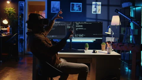 Self employed engineer using technologically advanced VR glasses to do coding Stock Footage 265619409