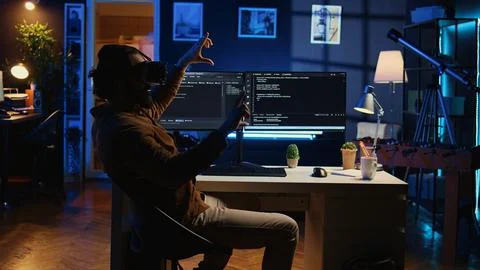 Self employed engineer using technologically advanced VR glasses to do coding 스톡 사진