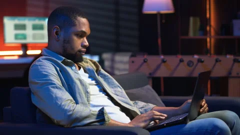 Self employed guy browsing the web and listening to music Stock Footage 308261628