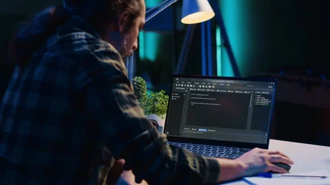 Self employed IT specialist working on fixing database errors from home 動画素材 263854555