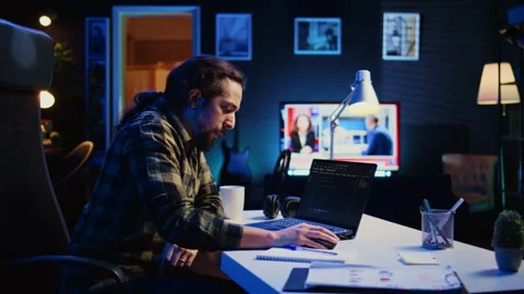 Self employed IT specialist working on fixing database errors from home 動画素材 263933054