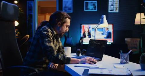 Self employed IT specialist working on fixing database errors from home Stock-Fotos