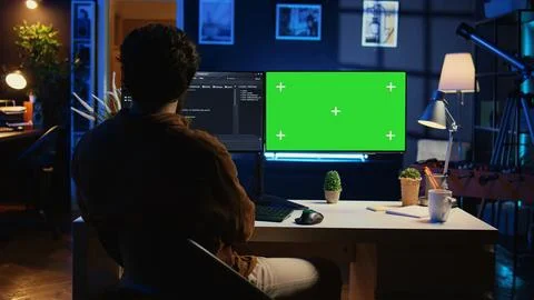Self employed man doing IT support job, coding on green screen PC 스톡 사진