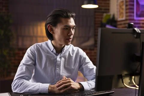Self employed man looking at computer screen during online class Stock Photos