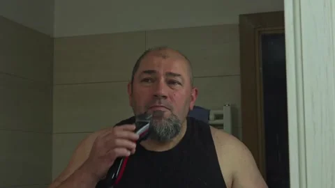Self-Grooming Session: Man Adjusting Beard Length on His Own Stock Footage 337164611