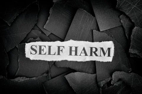 Self Harm. Torn pieces of black paper and words Self Harm. Concept Image Stock Photos