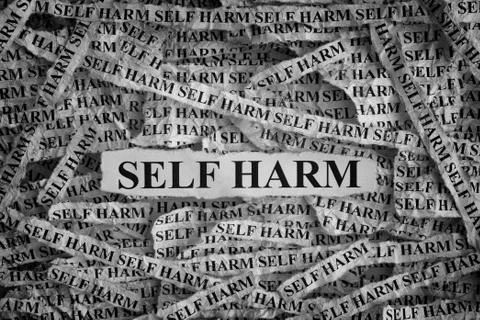 Self Harm. Torn pieces of paper with the words Self Harm Stock Photos