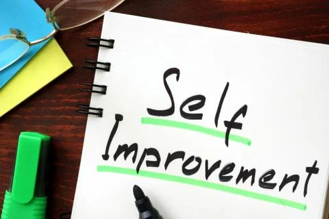 Self improvement sign written in a notepad. Stock Photos