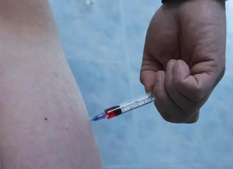 Self-injection of an injection into the muscle Stock Photos