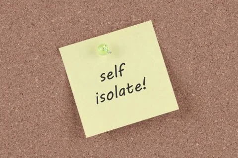 Self isolate post note on a cork notice board Stock Photos