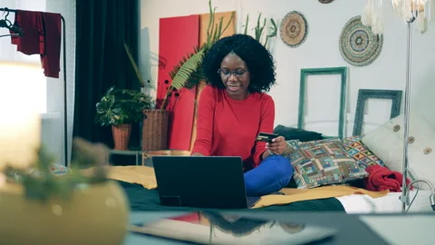 Self-isolation of an african lady doing online shopping Stock Footage 267529226
