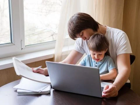 Self-isolation because of coronavirus outbreak. Man is remote working with hi Stock Photos