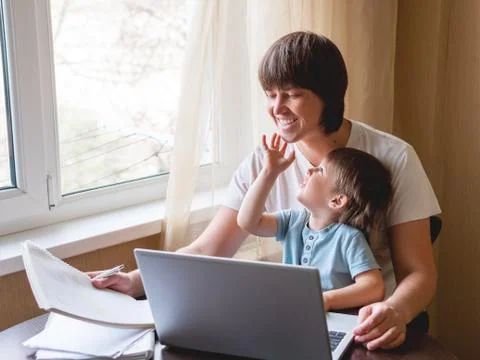 Self-isolation because of coronavirus outbreak. Man is remote working with hi Stock Photos