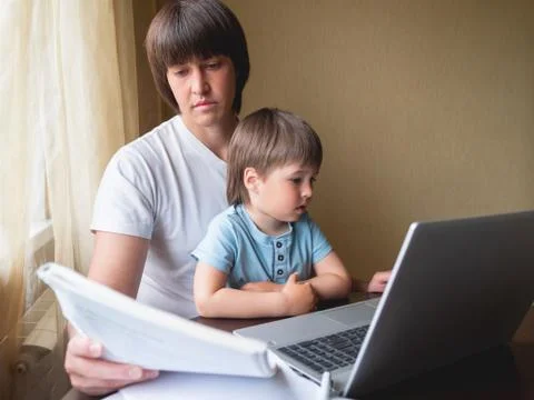 Self-isolation because of coronavirus outbreak. Man is remote working with hi Stock Photos