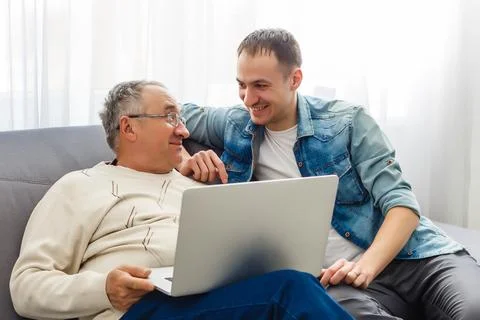 Self-isolation because of coronavirus outbreak. Father is remote working with Stock Photos