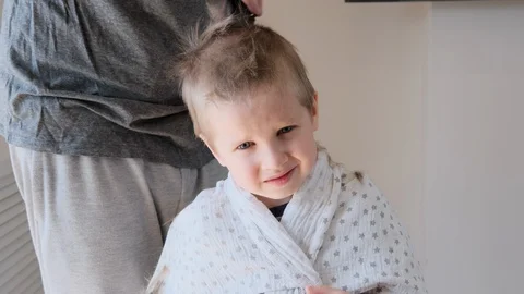 Self-isolation concept. Father cutting the hair of a little son with a hair Stock Footage 129148208