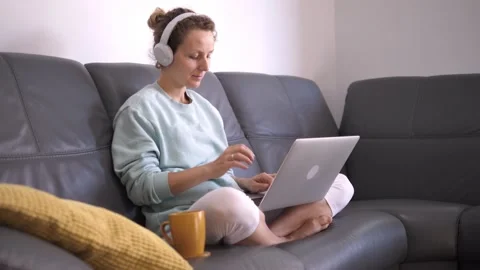 Self-isolation during coronavirus crisis. Young woman remotely working on laptop Video stock 141521252