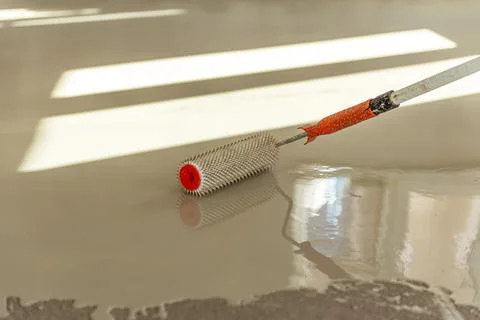 Self-leveling epoxy. Leveling with a mixture of cement floors. Stock Photos