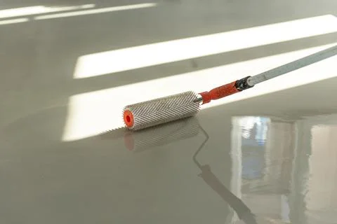 Self-leveling epoxy. Leveling with a mixture of cement floors. Stock Photos